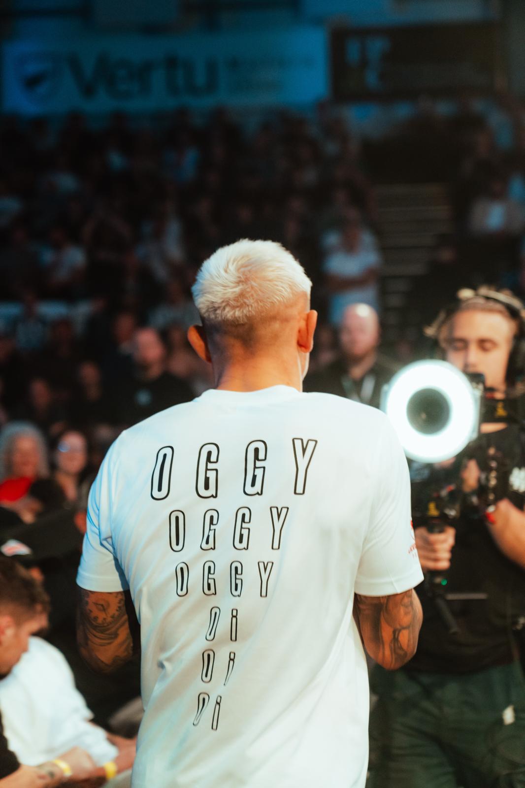 A fighter walking out in front of a live crowd